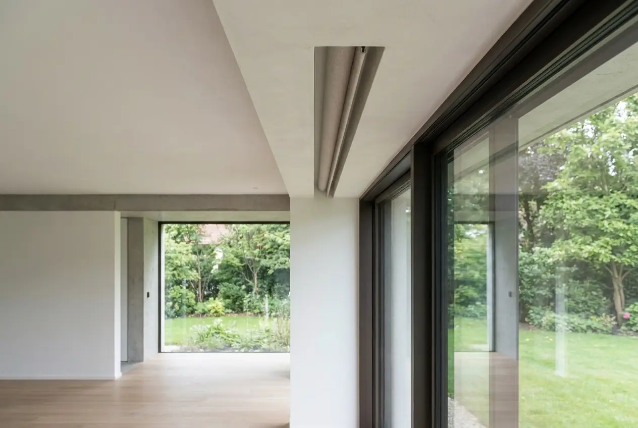 Close-up of a concealed ceiling-recess blind box in a modern architect-led Forest Town extension, fabric edge visible beneath the plaster reveal